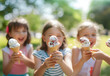 © Daniel - Group of children in the park eating cold ice cream.
