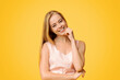 © Prostock-studio - Natural Beauty. Portrait Of Cute Teen Girl With Blonde Hair And Charming Smile Posing Over Yellow Background, Copy Space