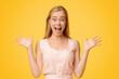 © Prostock-studio - Unbelievable Luck. Euphoric Young Girl Raising Hands And Shouting With Excitement, Rejoicing Success Over Yellow Background