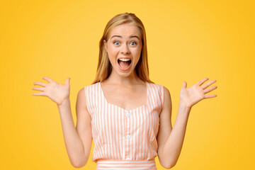 Wall Mural - Unbelievable Luck. Euphoric Young Girl Raising Hands And Shouting With Excitement, Rejoicing Success Over Yellow Background