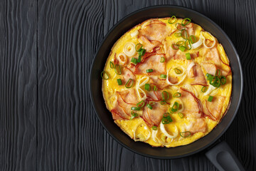 Canvas Print - deli ham onion omelette on skillet, top view