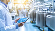 © Nataliia - Scientist using a tablet to monitor data in a modern pharmaceutical or chemical manufacturing facility