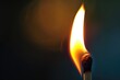 © Sarinrata - Closeup of a single wooden match igniting with bright flames, capturing the initial spark