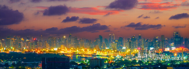 Wall Mural - Night view of city silhouettes of buildings and skyscrapers, the dying sky after sunset and clouds