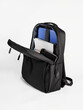 © Lina Solntseva  - black backpack with contents, books and laptop on a white background
