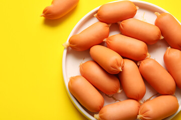 Canvas Print - Plate of tasty boiled sausages on yellow background