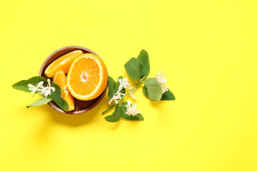 Sticker - Bowl of oranges with blooming branches on yellow background