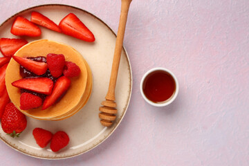 Wall Mural - Plate with sweet pancakes, berries and honey on pink background