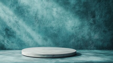 A circular stone platform on a teal textured surface creates a minimalist and modern display area, accentuating the geometric form and the contrasting background material.