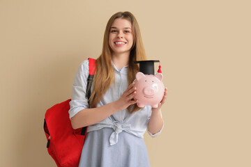 Poster - Female student with piggy bank in graduation hat and backpack on beige background. Concept of savings for education