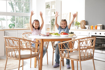 Canvas Print - Happy little girls with tasty toasts at table in kitchen