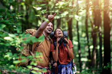 Love couple hiking through forest