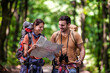 © ivanko80 - Hiker couple in the forest using map
