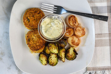 crab cakes  with sheared scallops and roasted brussel sprouts