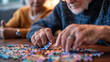 © Chatchanan - Nurse aiding senior man in playing alphabet puzzle, promoting mental wellness in geriatric clinic