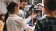 © Chatchanan - Real scientist teaching children about robotics, showcasing a robotic arm in the laboratory