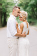 © anatoliycherkas - Romantic Couple Embracing In Nature, Smiling And Enjoying A Tender Moment Together