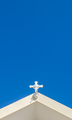 Cross with blue sky background on The Cathedral of the Immaculate Conception is a Catholic cathedral church located in the city of Dili, the capital of East Timor. 