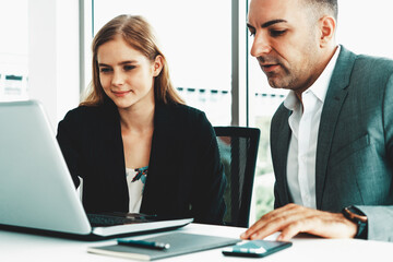 Wall Mural - Businessman executive is in meeting discussion with a businesswoman worker in modern workplace office. People corporate business team concept. uds