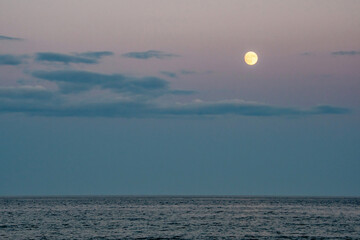 Wall Mural - full moon rises over the atlantic ocean