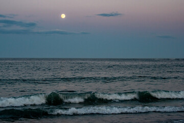 Wall Mural - full moon rises over the atlantic ocean