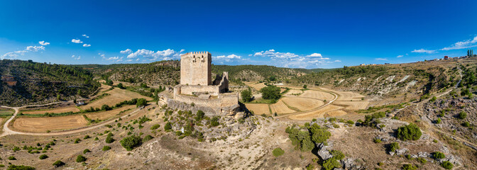 Wall Mural - Aerial view of Paracuellos de la Vega Spanish medieval castle perched on a rock in Cuenca, square tower surrounded by curtain wall with small circular turrets