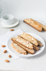 Wall Mural - almond biscotti on a white plate, almond cantucci cookies on a white plate