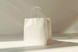 © Ева Поликарпова - A white paper bag sits on a table, ready for use or disposal