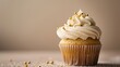 © Sinechana - 4. A deliciously decorated cupcake featuring cream cheese frosting and golden sugar sprinkles, captured on a light background with ample negative space for banner text