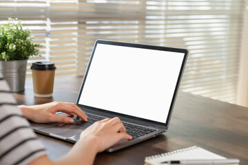 Wall Mural - Woman hand using laptop and type on the keyboard, Mockup screen of advertisement.