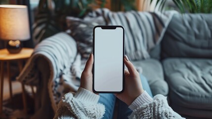 Aufkleber - Mock up white screen blank mobile phone in woman hands holding sitting on armchair at home Back view : Generative AI