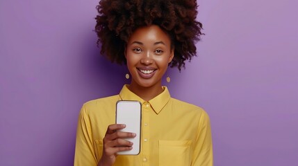 Fototapete - Young positive casual African American woman holds out phone with white screen to camera recommending using store mobile application for online shopping stands in purple studio Mock up : Generative AI