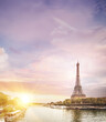 © Kotkoa - Romantic sunset background. Eiffel Tower with boats on Seine river in Paris, France
