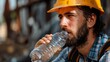 © Generative AI - Dangerous from heat wave during working outside the building Caucasian male construction worker resting and drinking water from bottle in a very hot day Heat stroke health problem : Generative AI