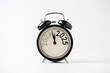 © Dilok - 2024 and 2025 on black alarm clock on white background with copy space  for preparation of Merry Christmas and Happy new year concept.