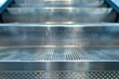 © VolumeThings - Close up of metal steps on an escalator with copy space