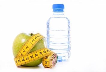 Sticker - green apple with meter tape and bottle of water isolated on white background