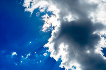 Wall Mural - Background with a large dark cloud and sunbeams after rain. Substrate with empty space for text.