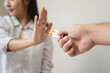 © Pormezz - person showing hand sign to rejection cigarette for quit smoke motivation.