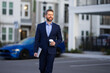 © Volodymyr - Business man in suit walk outdoor in street. Businessman in city. Business man in suit go to office work. Business people. 40s office worker. Outdoor portrait of businessman near office building.