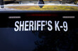 © F Armstrong Photo - Signs warning that a K-9 dog is in a Sherriff's vehicle