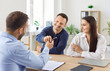 © Studio Romantic - Family couple, as customers, signing a contract with a financial consultant or investment agent during an office meeting. This signing marks an important step in investment journey.