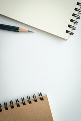 Wall Mural - open blank spiral notebook with black pencil on white background. empty space for your text.