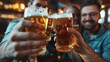 © liliyabatyrova - A group of people are holding up their beer glasses in a bar