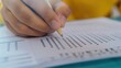 © Anna - A student carefully marks responses on a standardized test using a pencil, demonstrating focus and diligence in a bright learning environment