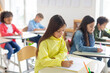 © Home-stock - Junior school children writing in their copybooks, having exam, creating studious atmosphere in classroom interior