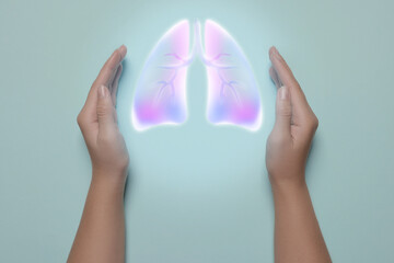 Canvas Print - Woman holding hands near illustration of lungs on light blue background, closeup. Asthma and other respiratory diseases