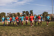 © Westend61 - Rugby players running together under cloudy sky at sports field