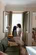 © ADDICTIVE STOCK CORE - Cheerful couple of lesbian women kissing at home