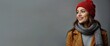 © Pham Ty - Banner with a smiling woman with wavy hair is wearing an red hat and a matching scarf. Gray background with space for texts